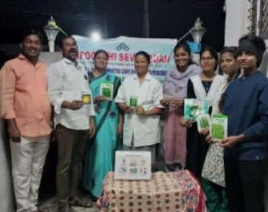 Participants holding seed packets at the health education program reported in the newspaper